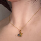 5mm round Australian opal triplet pendant worn at the neck, yellow gold-plated silver
